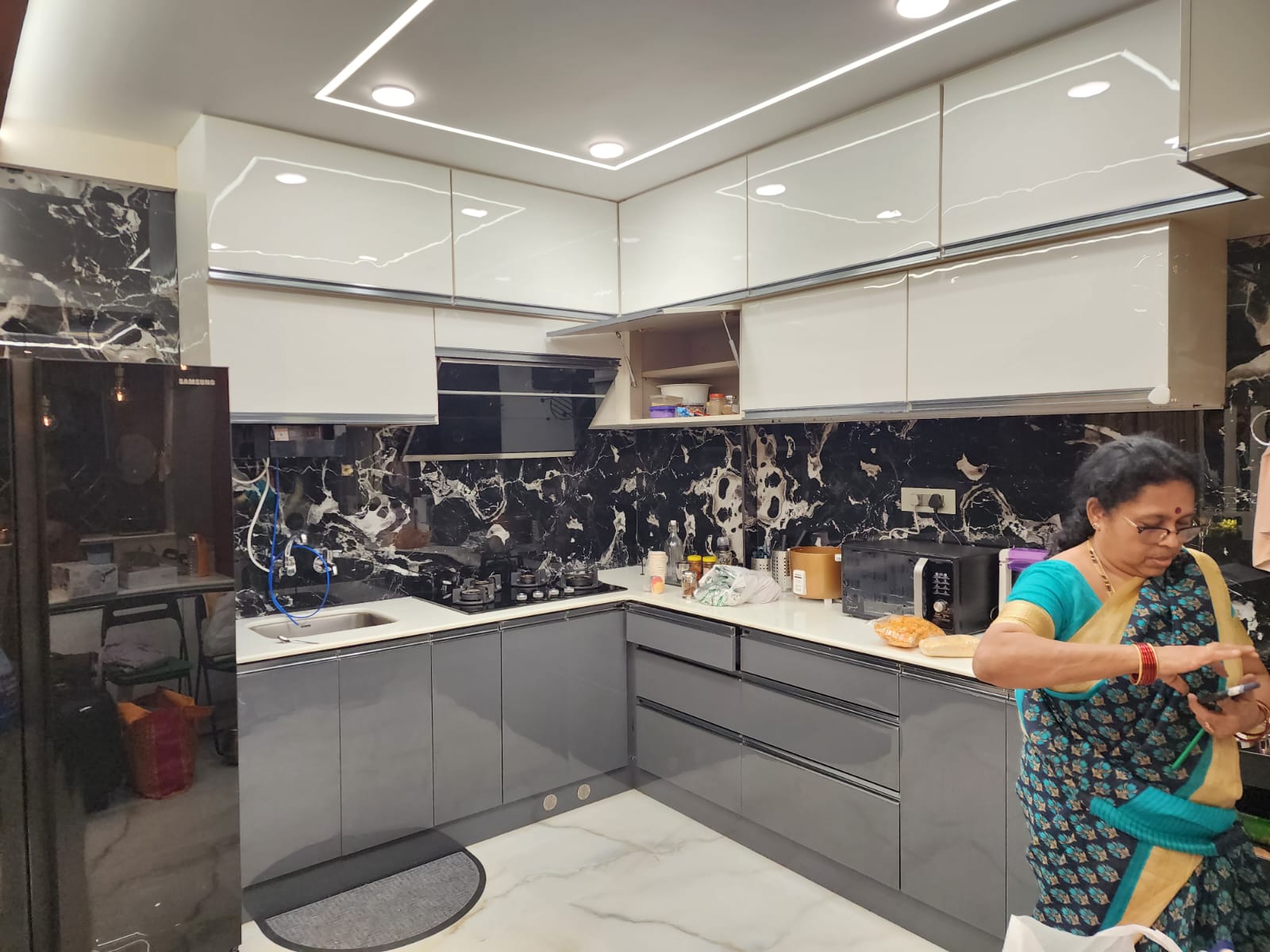 L-shape modular kitchen with glossy shutters in Vizag
