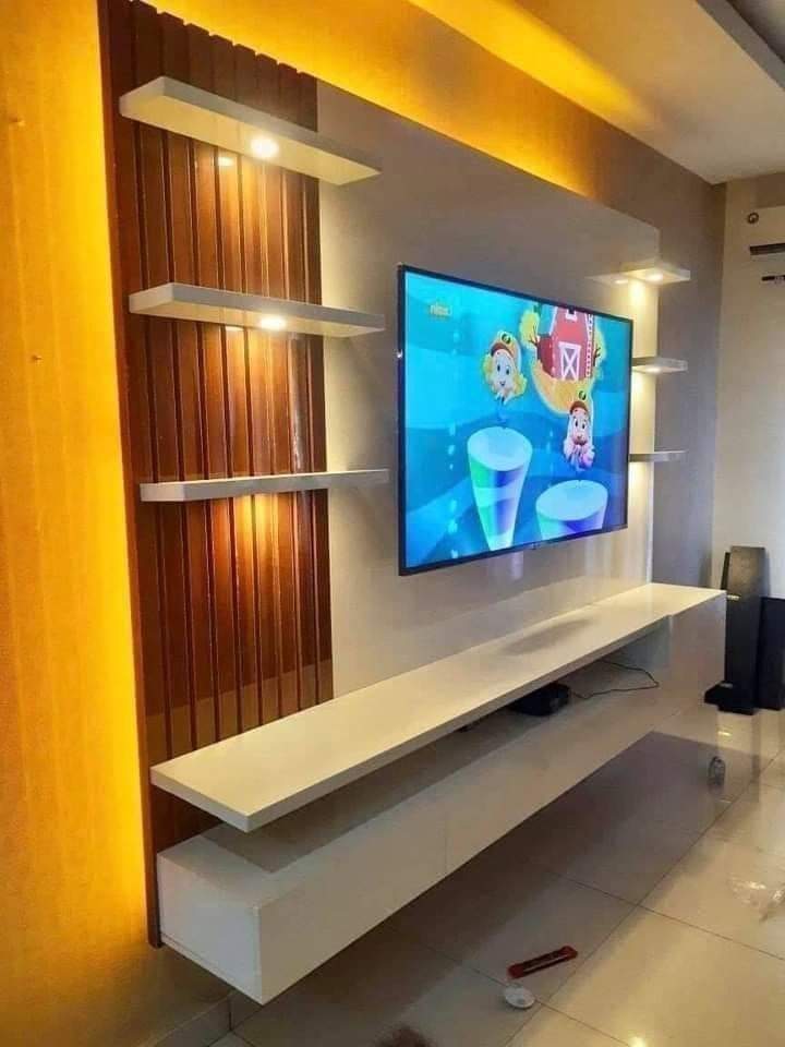 Floating TV unit with wooden louver backdrop in Vizag