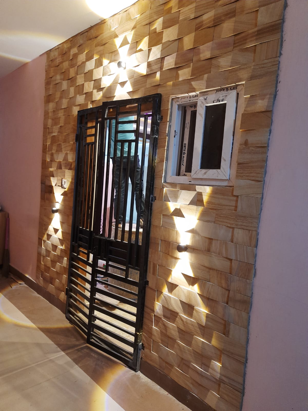 Wooden cladding feature wall with up-down lights in Vizag